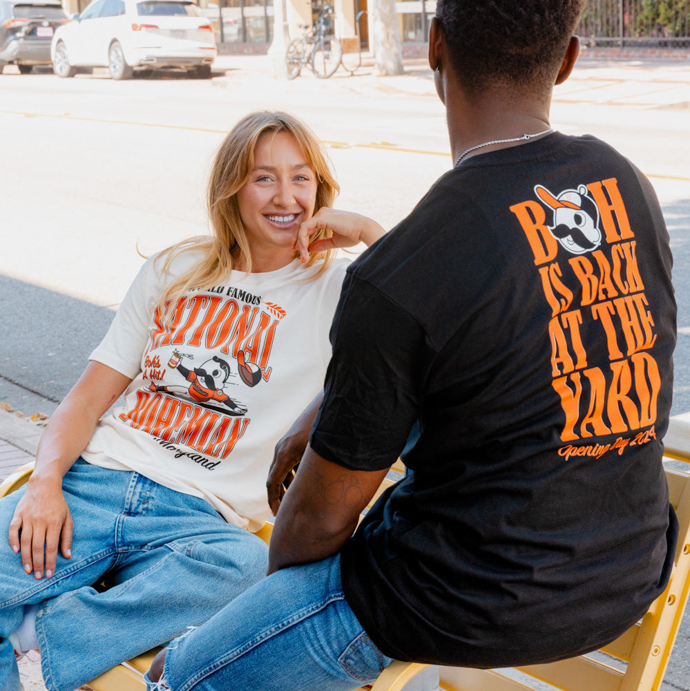 Woman and man wearing National Bohemian graphic tees.